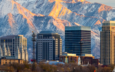 A city with tall buildings and mountains in the background.