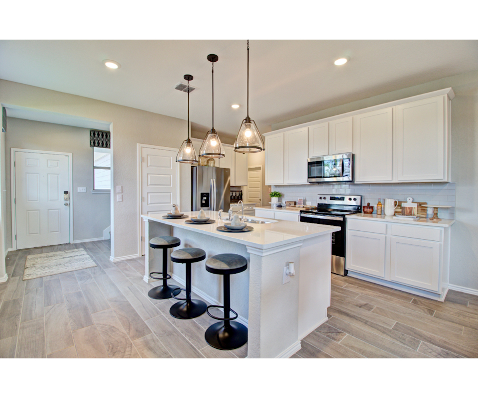 White kitchen with barstools at island