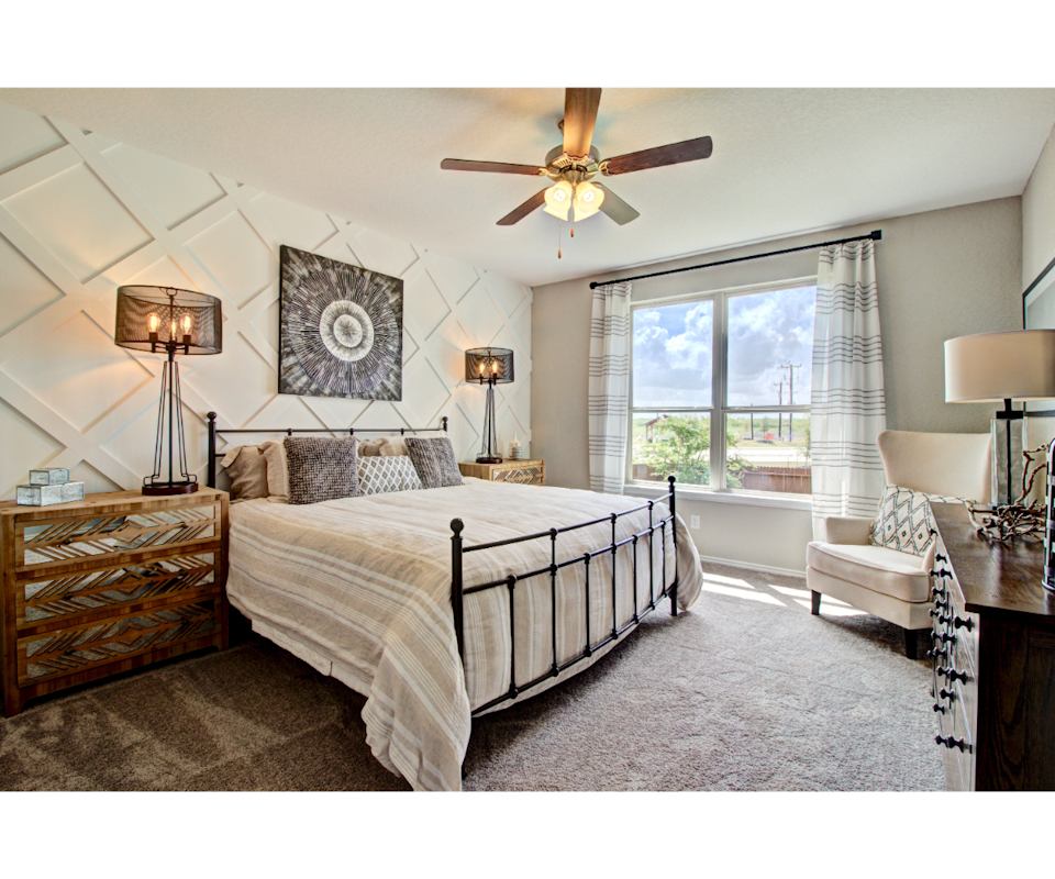 Bedroom with ceiling fan and furnishings