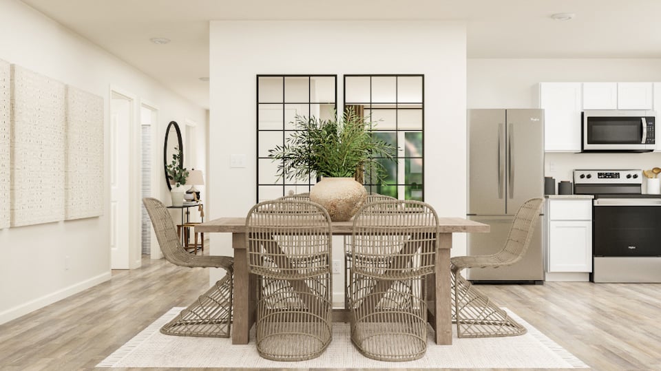 A dining room with a table and chairs.