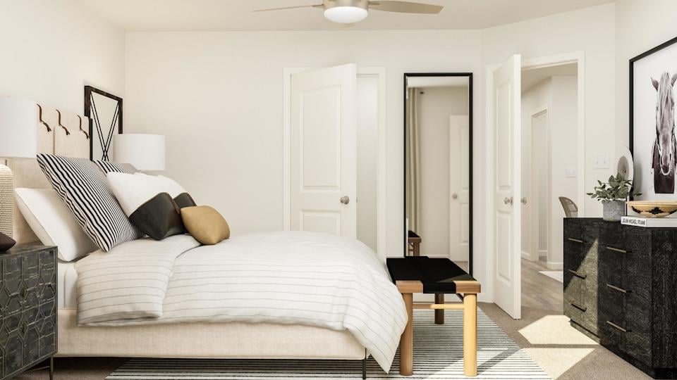 A bedroom with a bed and a table.